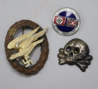 A German enamel war badge, a cap skull and a paratrooper badge, make G.W.L.
