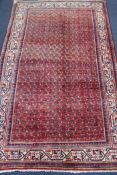 An Araak red, blue and cream ground rug, 200 x 127cm