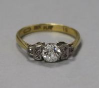 An 18ct gold single stone diamond ring with diamond set shoulders, stamped 18ct Plat