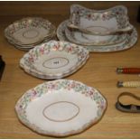 An early 19th century Derby matched part dinner service, decorated with rose garlands, sprigs and