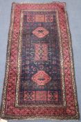 A red and blue ground rug, 155 x 78cm