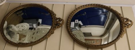 A pair of gilt gadroon framed convex wall mirrors, H.51cm