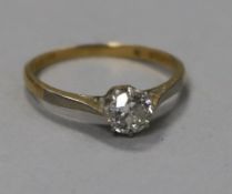 An 18ct gold and platinum solitaire diamond ring, stamped 18ct pt