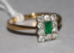 An 18ct gold emerald and diamond plaque ring