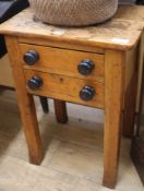 A pine two drawer table, with ebonised turned handles