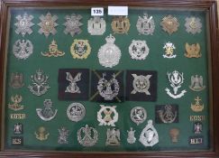 A framed collection of military badges