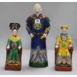 A pair of Chinese polychrome pottery figures, seated Emperor and Empress, and another of an official