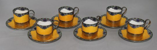 A set of six Royal Worcester silver-mounted coffee cans and saucers, with six enamelled silver-