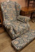 A Victorian wing back armchair and foot stool