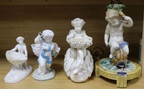 A Majolica putti lamp and three putti table centres (some damage)
