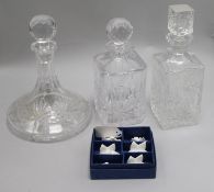 A cut glass 'ship's' decanter, two other decanters and stoppers and a set of Coalport menu