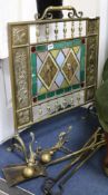 A Victorian aesthetic firescreen, fire irons and andirons