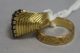 An 18ct gold band and a gold and sapphire ring