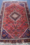 A Persian red and blue ground rug, 210 x 135cm