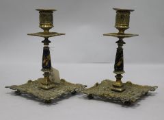 A pair of French brass and enamel candlesticks