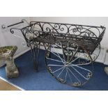 A wrought iron wheelbarrow planter, W.170cm