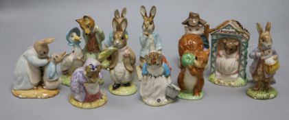 A collection of twelve Royal Albert Beatrix Potter figures, including 'Mrs Rabbit Cooking' (