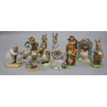 A collection of twelve Royal Albert Beatrix Potter figures, including 'Mrs Rabbit Cooking' (