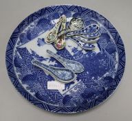 A large Japanese blue and white charger and a collection of ceramic spoons