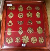 A framed collection of military badges