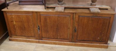 An oak three door low cupboard, W.194cm