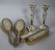 A pair of 1970's silver candlesticks and a silver four piece brush set.