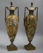 A pair of gilt brass and marble urns