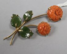 A gold, carved coral and jade rose brooch, 50mm.