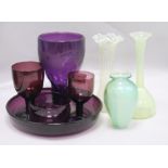 A group of amethyst glass and three vaseline glass vases