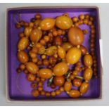 Two amber bead necklaces and a quantity of loose amber bead, gross 63 grams.