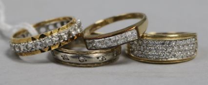 An 18ct gold Zirconium-set ring, two similar 9ct gold rings and another stone-set unmarked ring