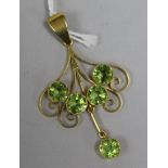 An 18ct gold openwork scroll pendant set with five large peridots, 52mm.