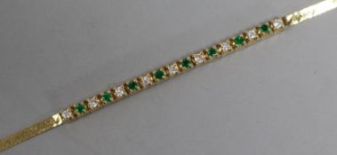 A 14ct gold, emerald and diamond small line bracelet, 15cm.