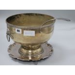A silver plated bowl, ladle and stand