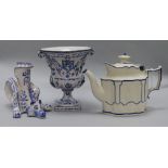 A Continental blue and white figural animal candlestick, an urn-shaped vase and a Castleford