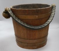 A wooden bucket bearing a coat of arms