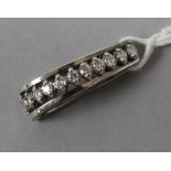 A white gold and diamond set scarf toggle, 26mm.