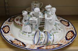A pair of figurines, cups, meat plates
