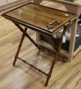 An Indian walnut butler's tray on turned simulated bamboo folding stand, H.68cm