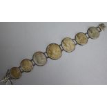 A 19th century lava cameo bracelet in white metal setting set with seven graduated oval stones