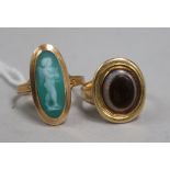A 19th century Italian yellow metal cameo ring and and an onyx and yellow metal ring.
