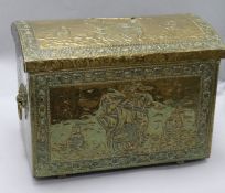 An embossed brass coal / log bin