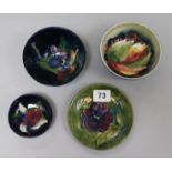 Three Moorcroft floral bowls, a dish and a vase