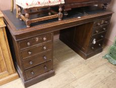 An early 20th century oak pedestal desk, W.143cm