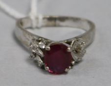 A ruby and diamond ring in white metal setting and triangular shaped shank, size H/I