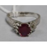 A ruby and diamond ring in white metal setting and triangular shaped shank, size H/I