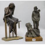 A bronzed statue of a seated lady and another figure