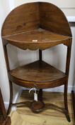 A George III boxwood line-inlaid three-tier corner washtand, bow-fronted, with tray top and