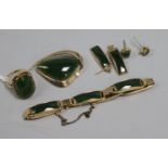 A suite of 9ct gold and jade jewellery, comprising bracelet, ring and two pairs of earrings and a