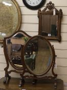 A mahogany shield-shaped skeleton toilet mirror, a similar oval mirror and a gilt-framed wall mirror